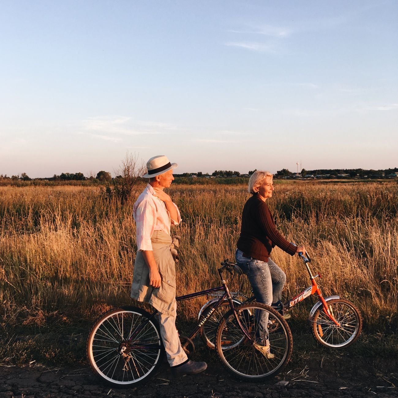 A senior couple enjoying an evening in a scenic grass field